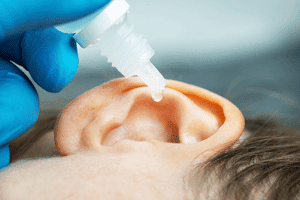hydrogen peroxide drops going into a child's ear
